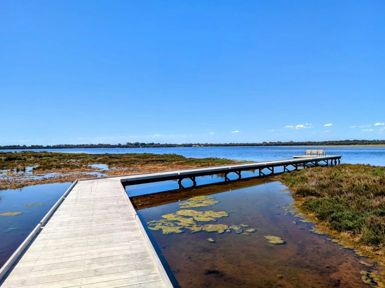 a wooden dock sitting next to a body of water